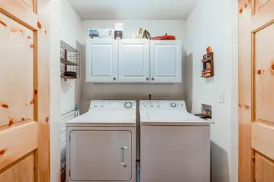 a small kitchen with white cabinets and a dishwasher at Tavern Inn #39 in Olympic Valley