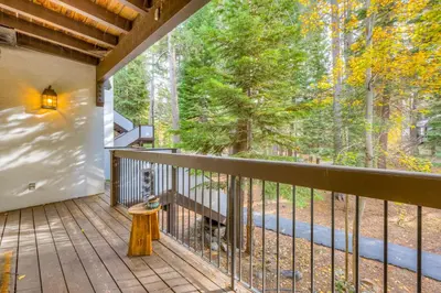a balcony with a view of the woods at Tavern Inn #39 in Olympic Valley