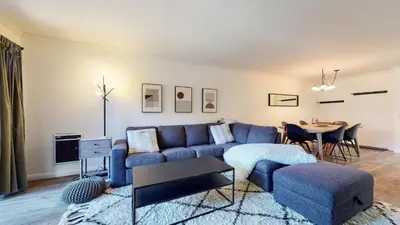 a living room with a blue couch and a table at Summit #105 condo in Mammoth Lakes