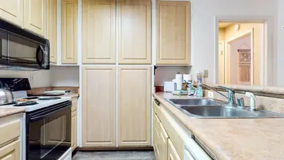 a kitchen with wooden cabinets and a sink at Summit #105 condo in Mammoth Lakes