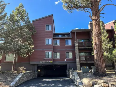 a red building with trees in front of it at Summit #105 condo in Mammoth Lakes