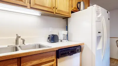 a kitchen with a sink and a refrigerator at Lakeview Villas #28 condo in Mammoth Lakes
