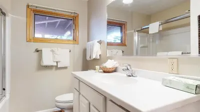 a bathroom with a sink and a toilet and a mirror at Lakeview Villas #28 condo in Mammoth Lakes