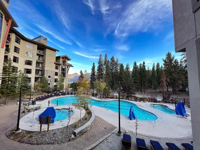 a swimming pool at a resort with a building at Village Monache #311 condo in Mammoth Lakes