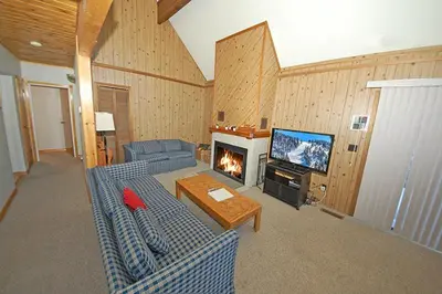 a living room with a blue couch and a fireplace at 1116 Golden Bear home in South Lake Tahoe
