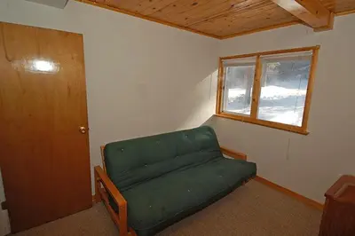 a living room with a green couch and a window at 1116 Golden Bear home in South Lake Tahoe