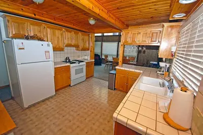 a kitchen with a white refrigerator and wooden cabinets at 1116 Golden Bear home in South Lake Tahoe