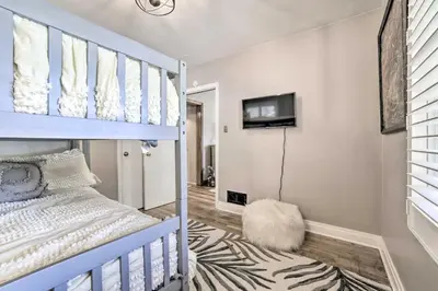 a bedroom with a bunk bed and a tv at Hot Tub and Walk to Midtown! Reno Retreat in Reno