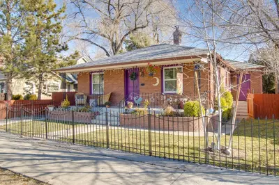 a house with a fence in front of it at Hot Tub and Walk to Midtown! Reno Retreat in Reno