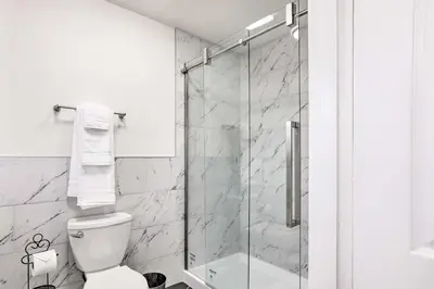 a bathroom with a toilet and a glass shower at Relax Fireside and Play Pool! Home 4 Mi to Dtwn Reno in Reno