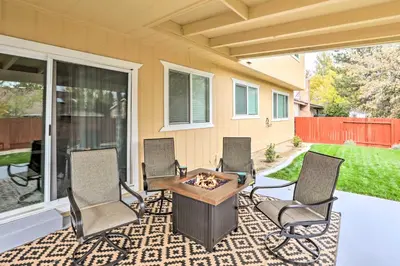 a patio with chairs and a table with a fire pit at Relax Fireside and Play Pool! Home 4 Mi to Dtwn Reno in Reno