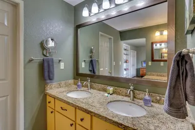 a bathroom with two sinks and a large mirror at Pet-Friendly Escape with Game Room and Fire Pit! in North Fork