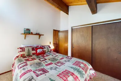 a bedroom with a bed and a wooden closet at Kings Beach Cozy in Kings Beach