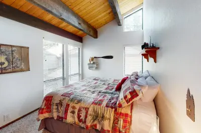 a bedroom with a bed with a quilt on it at Kings Beach Cozy in Kings Beach