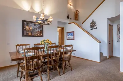 a dining room with a wooden table and chairs at Updated 3 Bedroom 3 Bathroom Snowcreek Phase V #884, Sleeps 6 in Mammoth Lakes