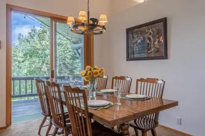 a dining room with a table and chairs and a window at Updated 3 Bedroom 3 Bathroom Snowcreek Phase V #884, Sleeps 6 in Mammoth Lakes