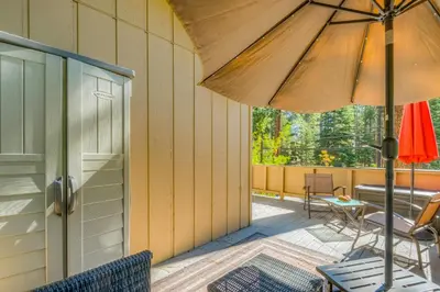 a patio with an umbrella and a table and chairs at Incline Village Charmer in Incline Village