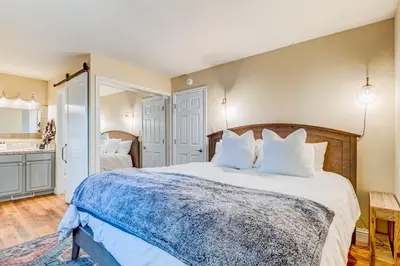 a bedroom with a large bed with white pillows at Incline Village Charmer in Incline Village