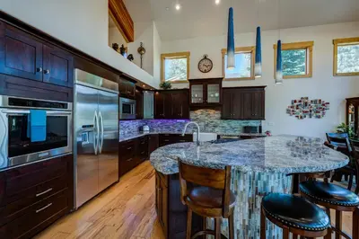 a kitchen with a large island with a granite counter top at Sierra Vista in Truckee