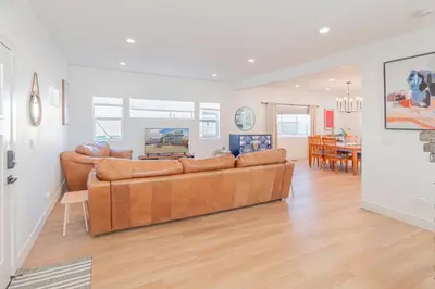a living room with a couch and a dining room at Luxury 4-bed home in Riverside Heights! in Reno