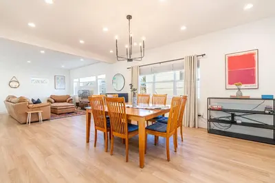 a dining room and living room with a table and chairs at Luxury 4-bed home in Riverside Heights! in Reno