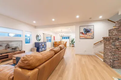 a living room with a couch and a brick fireplace at Luxury 4-bed home in Riverside Heights! in Reno