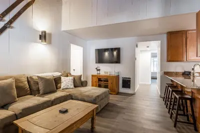 a living room with a couch and a table at Horizons IV 180 New Luxurious Listing Fully Remodeled 2 Bedrm Plus Loft 2 and a half Bathrm Sleeps 8 in Mammoth Lakes