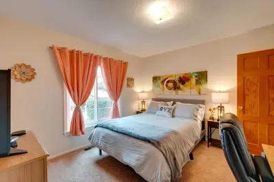 a bedroom with a bed and a desk and a window at Game Room and Patio Charming Jackson Retreat! in Jackson