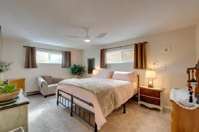 a bedroom with a bed and a couch at Game Room and Patio Charming Jackson Retreat! in Jackson