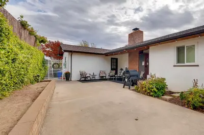 a house with a patio with a table and chairs at Game Room and Patio Charming Jackson Retreat! in Jackson