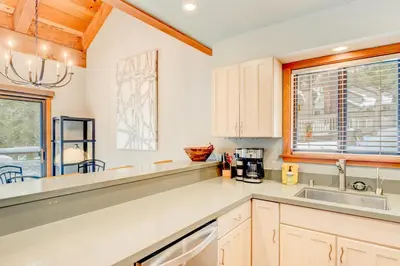 a kitchen with white cabinets and a sink at Granlibakken Getaway - #72A in Tahoe City