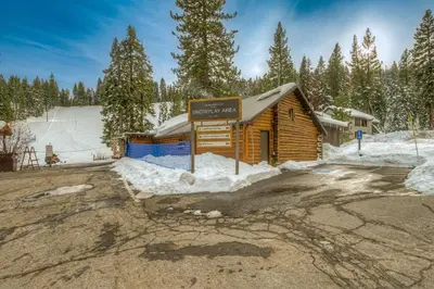 a sign in front of a cabin in the snow at Granlibakken Getaway - #72A in Tahoe City
