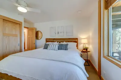 a bedroom with a large white bed and a window at 4 Mi to Slopes! Hot Tub Haven with Lake Tahoe Views in Incline Village