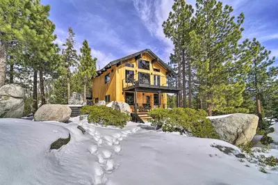 a wooden house in the woods in the snow at 4 Mi to Slopes! Hot Tub Haven with Lake Tahoe Views in Incline Village