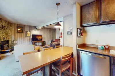 a kitchen with a table and a living room at Sherwin Villas 12 B in Mammoth Lakes