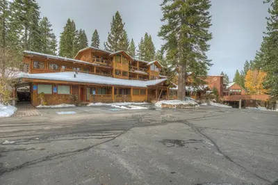 a large wooden house with a parking lot at Granlibakken Gem - Unit 71 in Tahoe City