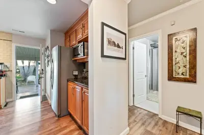 a kitchen with wooden cabinets and a refrigerator at Reno Roost in Reno