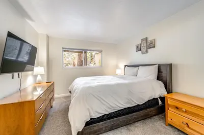a bedroom with a large bed and a television at Take Me to Tahoe in Incline Village
