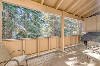 a screened porch with two chairs and two windows at Take Me to Tahoe in Incline Village