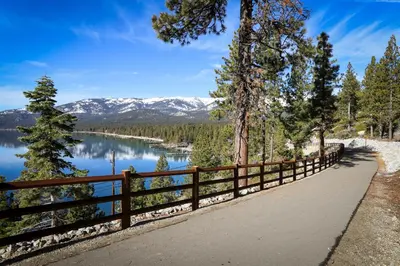 a path with a view of a lake and mountains at Take Me to Tahoe in Incline Village
