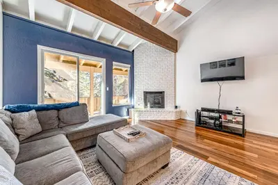 a living room with a couch and a tv at Take Me to Tahoe in Incline Village