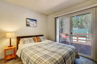 a bedroom with a bed and a sliding glass door at 1763 Saponi Street home in South Lake Tahoe