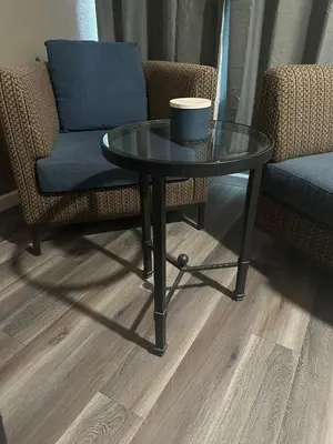 a table and a chair with a cup on it at ROYAL MOTEL TRACY in Tracy