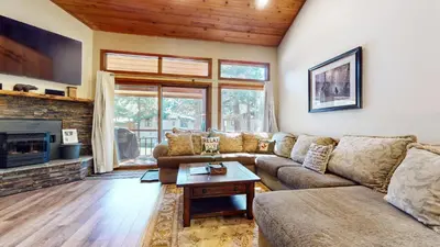 a living room with a couch and a fireplace at Woodlands #11 condo in Mammoth Lakes