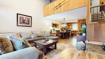 a living room with a couch and a table at Woodlands #11 condo in Mammoth Lakes