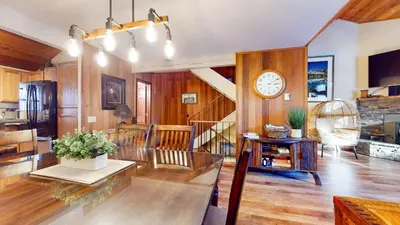 a living room with a clock on the wall at Woodlands #11 condo in Mammoth Lakes