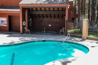a swimming pool in front of a house at Winterset #3 condo in Mammoth Lakes