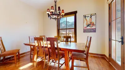a dining room with a wooden table and chairs at Snowcreek VI The Lodges #1167 condo in Mammoth Lakes