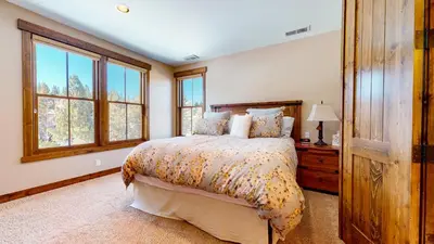 a bedroom with a bed and some windows at Snowcreek VI The Lodges #1167 condo in Mammoth Lakes