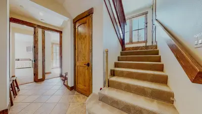 a staircase in a house with a door and aoyer at Snowcreek VI The Lodges #1167 condo in Mammoth Lakes